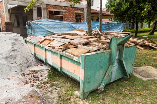 Workers sorting builders waste in Covent Garden urban setting.